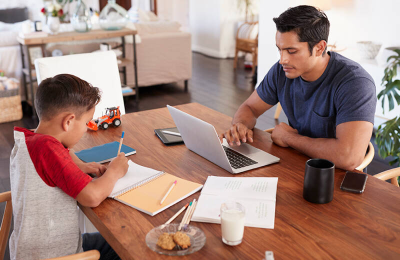father and son working at kitchen table